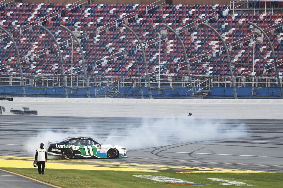 Justin Haley (11) does a burnout in front of empty seats after winning a NASCAR Xfinity auto race at Talladega Superspeedway in Talladega Ala., Saturday, June 20, 2020. (AP Photo/John Bazemore)