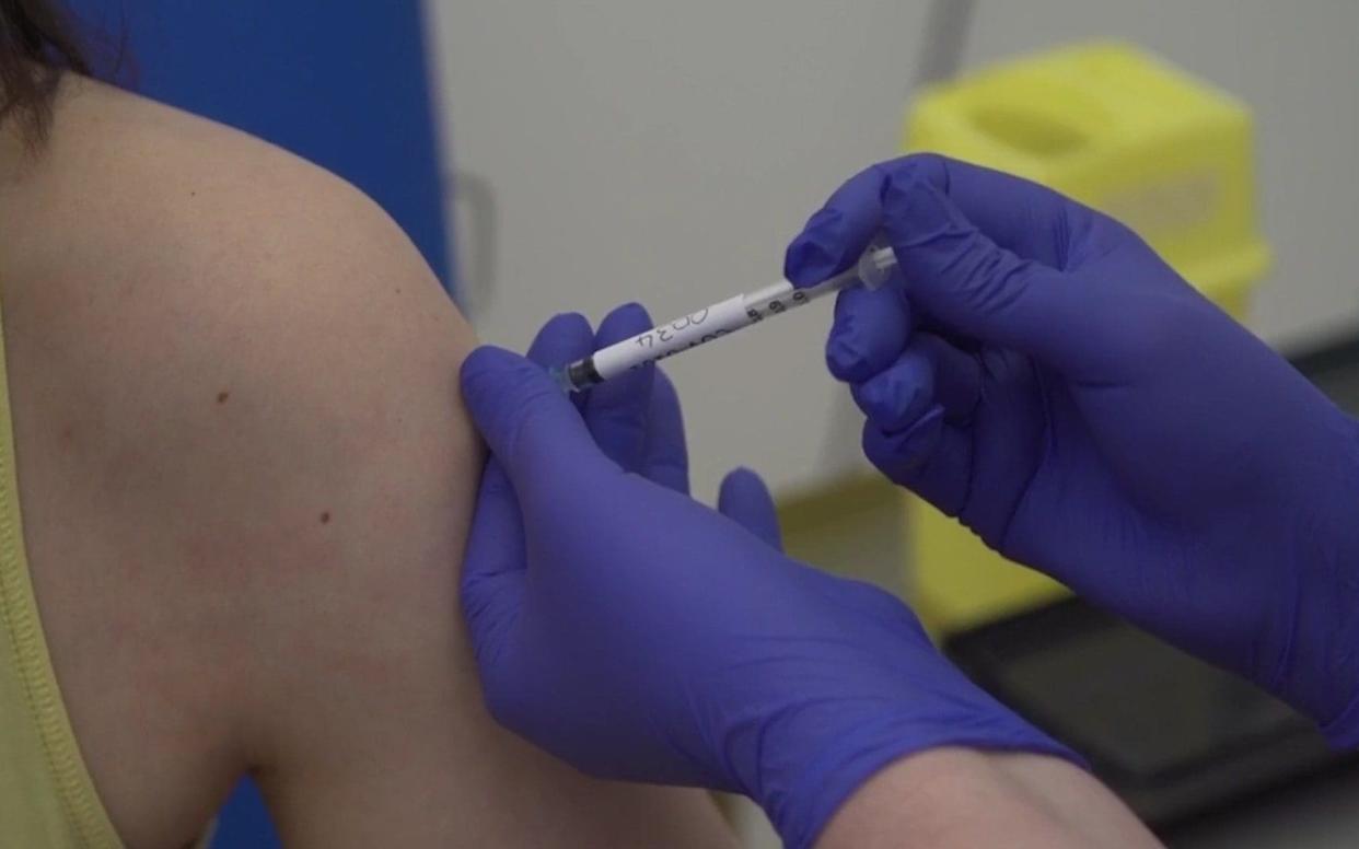 A patient is injected as part of human trials for Oxford University's vaccine - PA