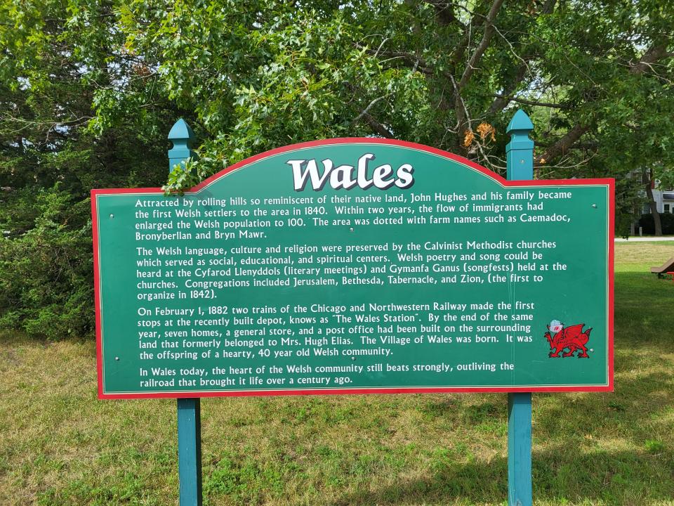 A sign along the Glacial Drumlin State Trail in the village of Wales explains the history of the community.