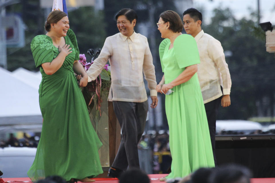 Philippine Vice President-elect Sara Duterte, left, the daughter of outgoing populist president of the Philippines, is greeted by incoming Philippine President Ferdinand "Bongbong" Marcos Jr. second from left, after oath-taking rites in her hometown in Davao city, southern Philippines on Sunday June 19, 2022. Duterte clinched a landslide electoral victory despite her father's human rights record that saw thousands of drug suspects gunned down. Also in photo are, from left, Supreme Court Justice Ramon Paul Hernando, her mother Elizabeth Zimmerman and Philippine President Rodrigo Duterte. (AP Photo/Manman Dejeto)