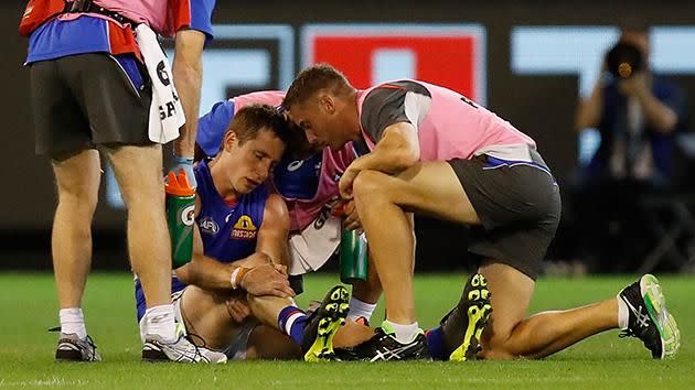 Dale Morris in the hands of the trainers. Pic: Getty