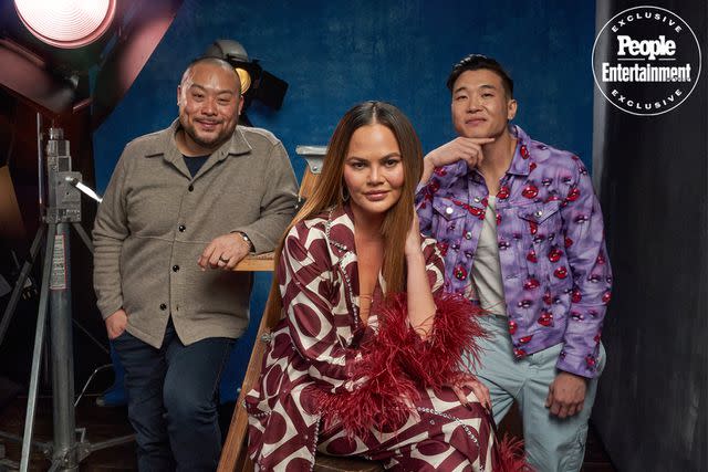 <p>PRESLEY ANN/SHUTTERSTOCK</p> Dave Chang, Chrissy Teigen and Joel Kim Booster