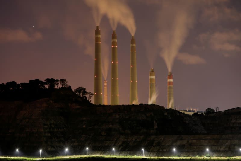 FILE PHOTO: Smoke and steam billows from the coal-fired power plant owned by Indonesia Power, next to an area for Java 9 and 10 Coal-Fired Steam Power Plant Project in Suralaya