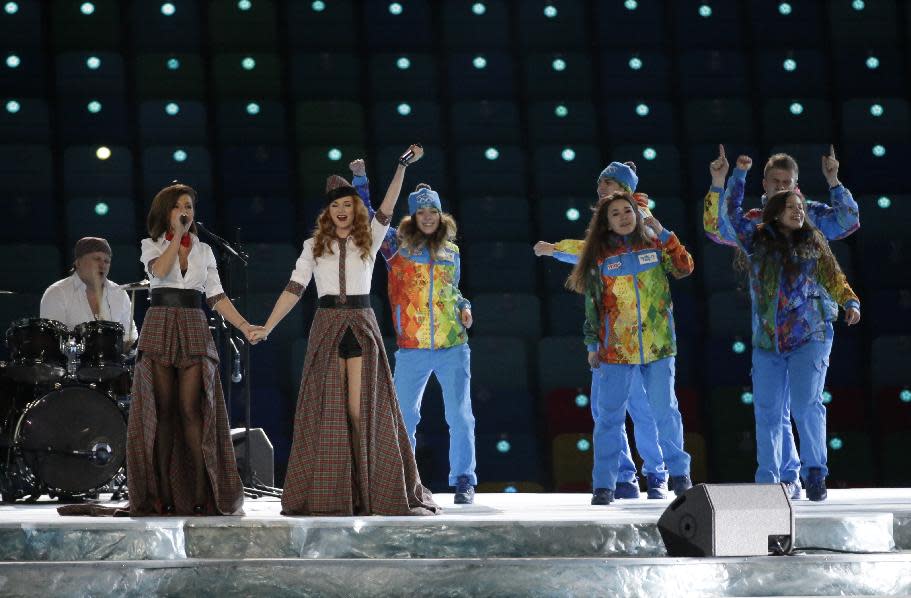 Russian duo t.A.T.u. Lena Katina, third from left, and Yulia Volkova, second from left, perform on stage before the opening ceremony of the 2014 Winter Olympics in Sochi, Russia, Friday, Feb. 7, 2014. (AP Photo/Mark Humphrey)