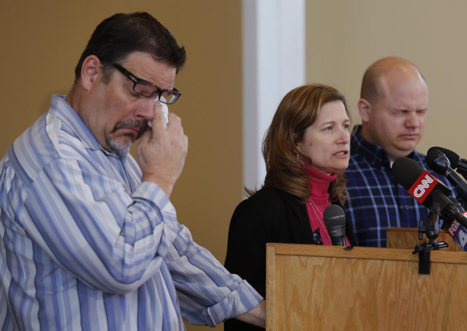 Will Corporon, left, and Tony Corporon, right, fight emotions while Mindy Losen, center, talks about her son and father during a news conference at their church in Leawood, Kan., Monday, April 14, 2014. Dr. William Corporon and his 14-year-old grandson were victims of Sunday's shooting at the Jewish Community Center. The three are sons and daughter of Dr. Corporon and Losen is the mother of the 14-year-old victim. (AP Photo/Orlin Wagner)