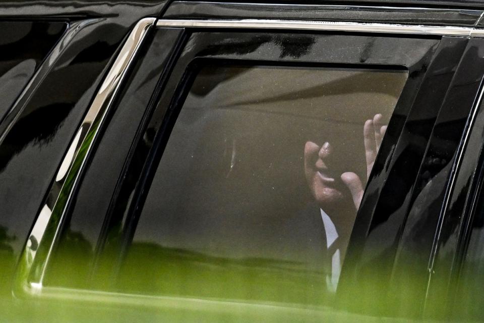 Former US President Donald Trump waves from his vehicle following his appearance at Wilkie D. Ferguson Jr. United States Federal Courthouse, in Miami, Florida, on June 13, 2023 (AFP via Getty Images)