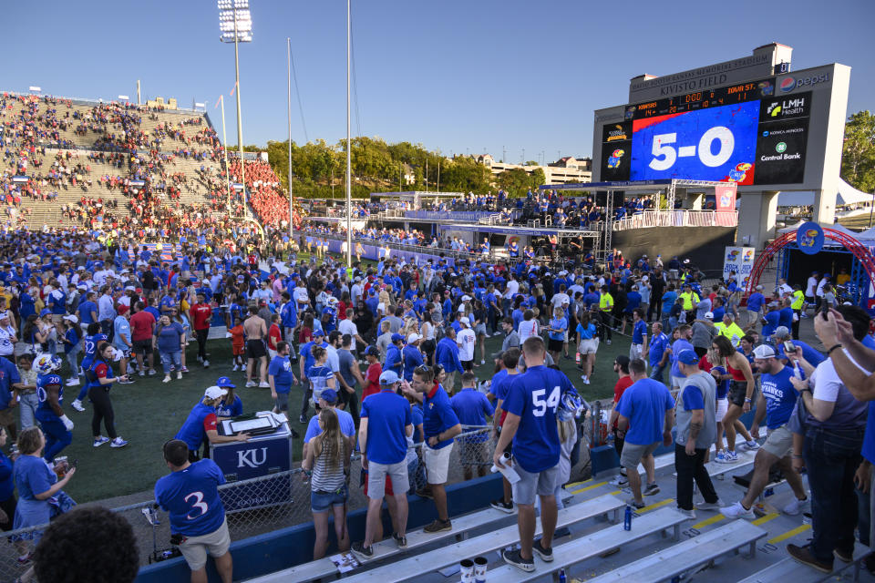 Kansas fans remain at the stadium after the team beat Iowa State 14-11 in an NCAA college football game, Saturday, Oct. 1, 2022, in Lawrence, Kan. (AP Photo/Reed Hoffmann)