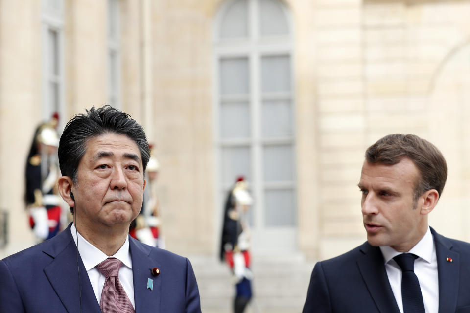 French President Emmanuel Macron, right, welcomes Japan's Prime Minister Shinzo Abe before their talks at the Elysee Palace, Tuesday, April 23, 2019 in Paris. (AP Photo/Thibault Camus)