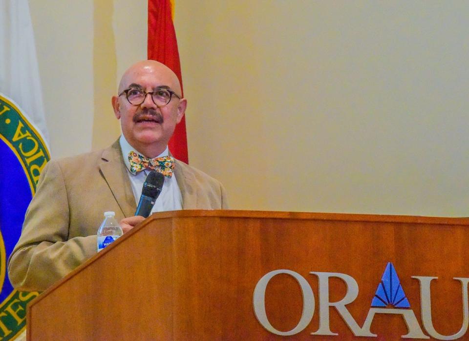 Eugenio Vargas, a retired Oak Ridge area neurosurgeon and Mexican immigrant, introduced the panel moderator at the "Roots of America" event: former Knoxville Mayor Madeline Rogero