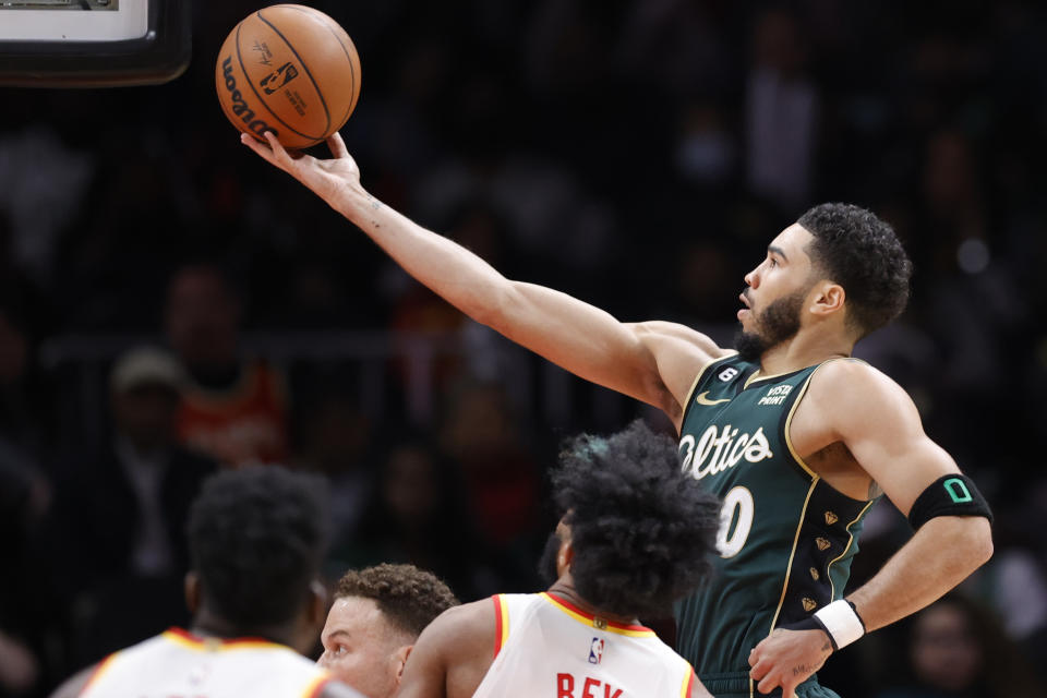 Boston Celtics forward Jayson Tatum, right, shoots over Atlanta Hawks forward Saddiq Bey during the first half of an NBA basketball game, Saturday, March 11, 2023, in Atlanta. (AP Photo/Alex Slitz)