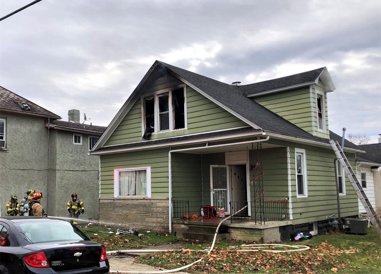 Firefighters work to contain a fire at 172 E Fair Ave. in Lancaster Tuesday morning. Lancaster Fire Capt. Slade Schultz said eight residents were displaced by the blaze, but there were no major injuries reported.