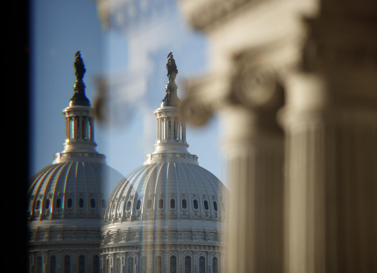 The U.S. Capitol Building Dome is seen through a beveled window at the Library of Congress in Washington, Wednesday, Dec. 19, 2018. President Donald Trump this week appears likely to pass up his last, best chance to secure funding for the “beautiful” wall he’s long promised to construct along the U.S.-Mexico border. (AP Photo/Carolyn Kaster)