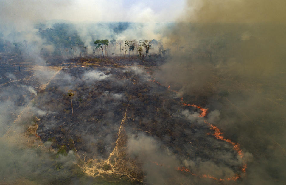 Fire consumes land deforested by cattle farmers near Novo Progresso, Para state, Brazil, Sunday, Aug. 23, 2020. Under military command, Brazil's once-effective investigation and prosecution of illegal rainforest destruction by ranchers, farmers and miners has come to a virtual halt, even as this year's burning season is about to begin. (AP Photo/Andre Penner)