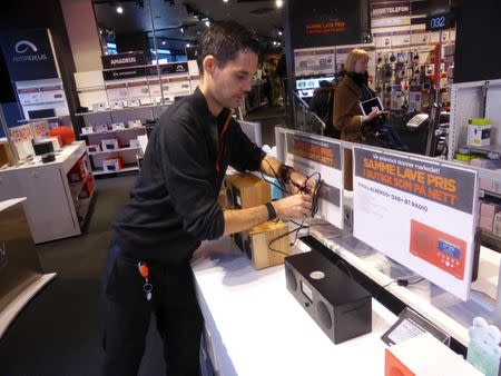 Worker Ino Andre Nilsen arranges digital radios in an Expert City electronics shop in Oslo, Norway January 4, 2017. REUTERS/Alister Doyle