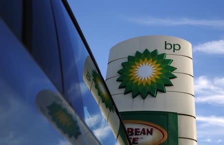 A BP logo is reflected in a car window at a petrol station in London January 15, 2015. BP is expected to announce job cuts in its North Sea operations on Thursday, the BBC reported. REUTERS/Luke MacGregor