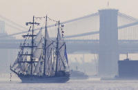 Tall ships travel up the Hudson River past New York City bridges as seen from Bayonne, N.J., Wednesday, May 23, 2012. Naval vessels ranging from a U.S. amphibious assault ship to a Finnish minelayer are participating in New York City's Fleet Week. (AP Photo/Seth Wenig)