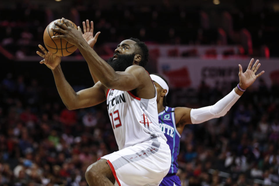 Houston Rockets guard James Harden, left, drives to the basket past Charlotte Hornets guard Devonte' Graham during the second half of an NBA basketball game in Charlotte, N.C., Saturday, March 7, 2020. (AP Photo/Nell Redmond)