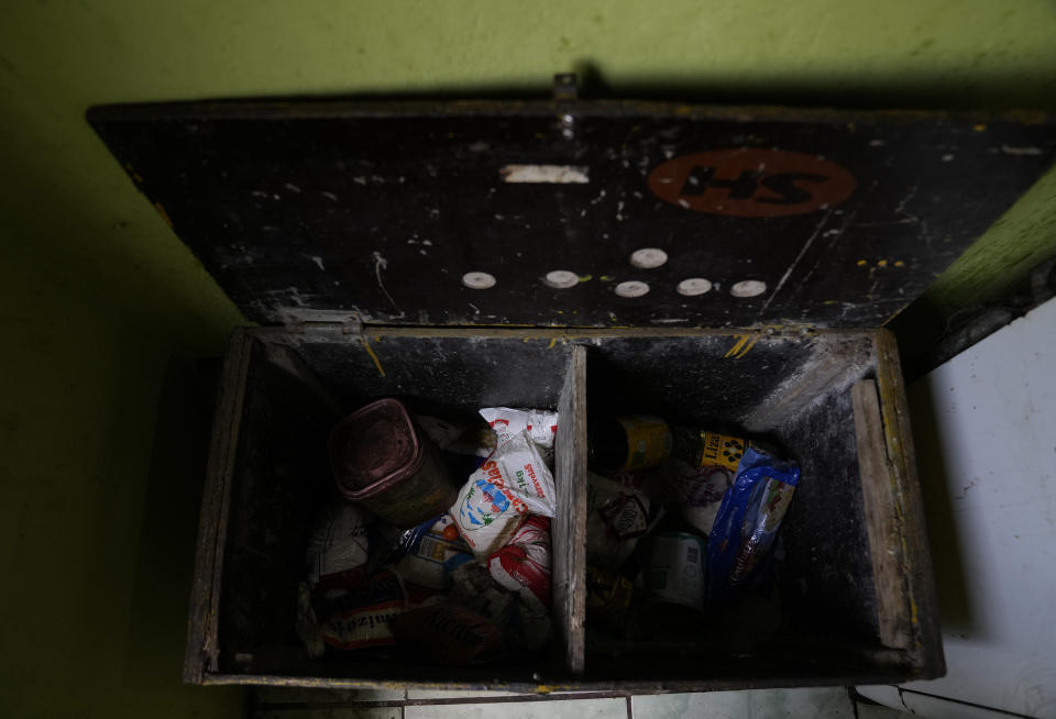 The pantry of Lady Laurentino, 74, is shown almost empty at her home in the Jardim Gramacho favela of Rio de Janeiro, Brazil, Monday, Oct. 4, 2021. Laurentino who now cooks with firewood instead of gas because of the recent surge in prices, says that at night she hopes it doesn’t rain. “There is no other way, I use firewood. If, at night, I can heat up the food, but if it rains, I eat it cold.” She says. (AP Photo/Silvia Izquierdo)