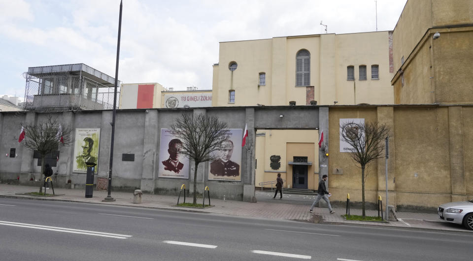 Aman walk front the 'Museum of Cursed Soldiers and Political Prisoners of the Polish People's Republic' in Warsaw, Poland, Tuesday, April 11, 2023. Israel's national Holocaust memorial, Yad Vashem, has criticized a new agreement renewing Israeli school trips to Poland, saying it recommends a number of "problematic sites" that distort history. (AP Photo/Czarek Sokolowski)