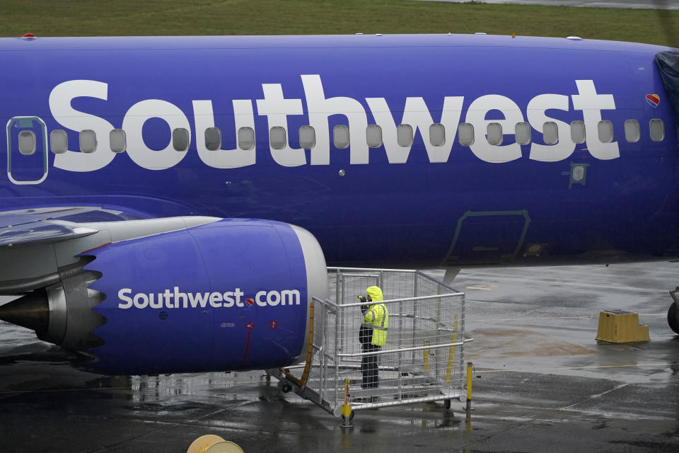 FILE - In this Wednesday, Nov. 18, 2020 file photo, a worker uses a flashlight to inspect an engine on a Boeing 737 Max 8 built for Southwest Airlines at Renton Municipal Airport in Renton, Wash. Southwest Airlines reports earnings on Thursday, Jan. 26, 2023. (AP Photo/Ted S. Warren, File)