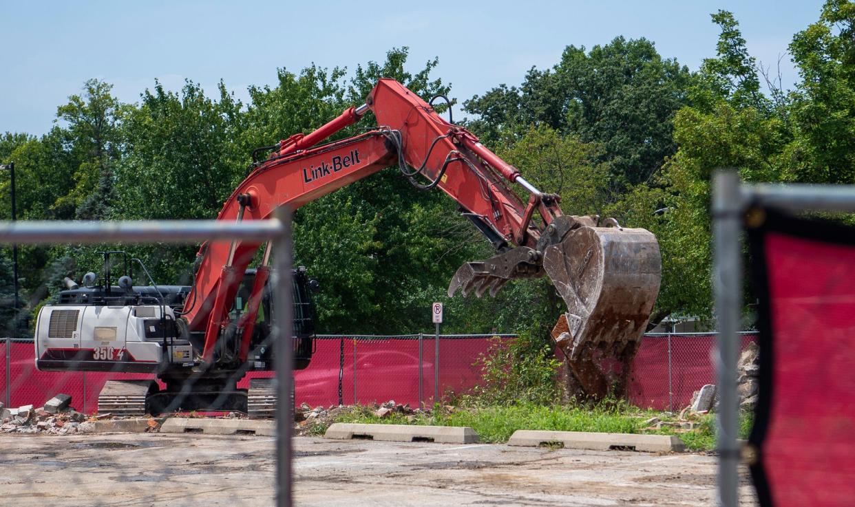 Construction crews work on cleaning up the site of the old Yogi's Bar & Grill on Friday, July 28, 2023.