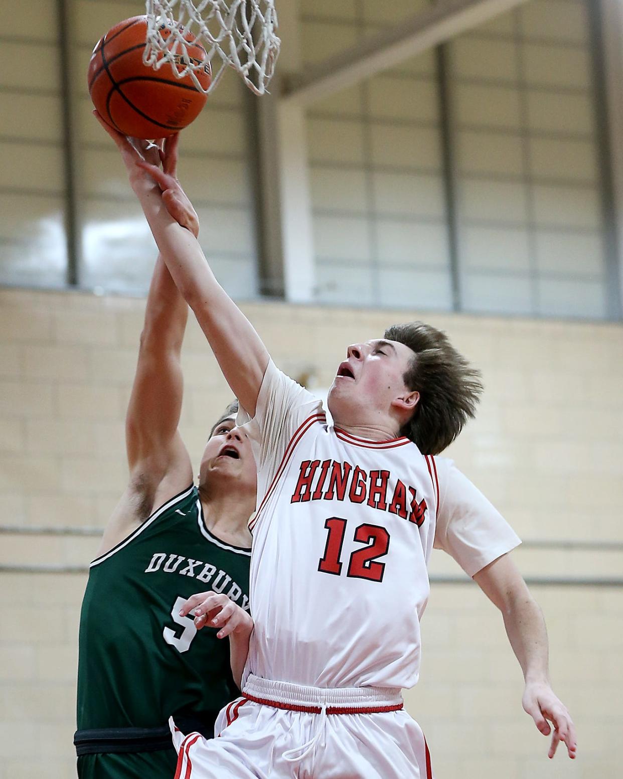 Hingham's Chase Mello earns a trip to the line after a foul by Duxbury's Carl Sundstrom on a fast break opportunity during third quarter action of their game against Duxbury at Hingham High on Friday, Feb. 10, 2023. 
