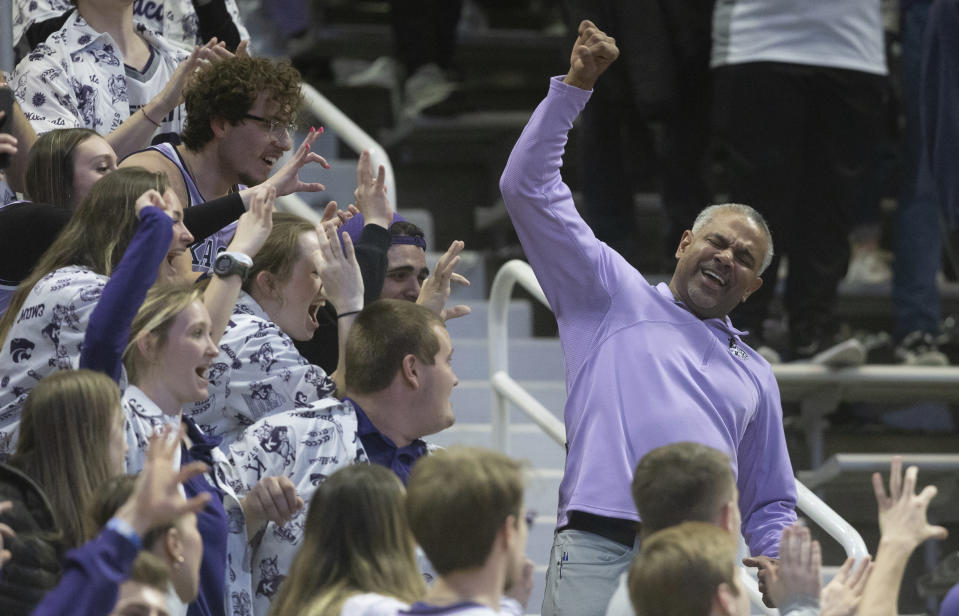 Kansas State coach Jerome Tang, right, celebrates with fans in the stands after his team defeated Iowa State in an NCAA college basketball game Saturday, Feb. 18, 2023, in Manhattan, Kan. (AP Photo/Travis Heying)
