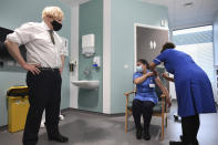 Britain's Prime Minister Boris Johnson watches as nurse Jennifer Dumasi is injected with the Oxford-AstraZeneca Covid-19 vaccine, during a visit to view the vaccination programme at the Chase Farm Hospital in north London, Monday Jan. 4, 2021, part of the Royal Free London NHS Foundation Trust. (Stefan Rousseau/Pool Photo via AP)