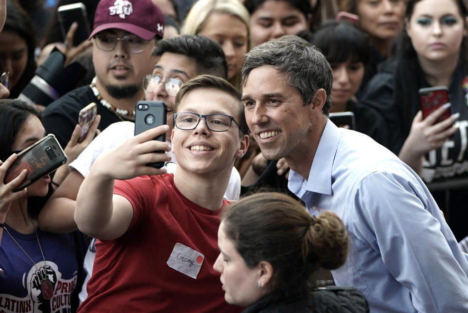 Democratic presidential candidate and former Texas congressman Beto O'Rourke, right, poses for a photograph with a supporter during his presidential campaign kickoff rally in Houston, Saturday, March 30, 2019. (AP Photo/David J. Phillip)