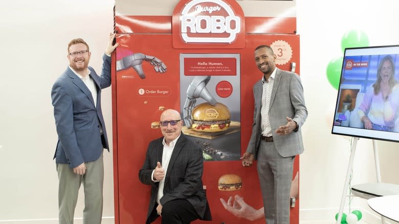 Founders of RoboBurger with machine