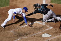 Chicago Cubs' Willson Contreras, left, is tagged out at home by Miami Marlins catcher Chad Wallach during the fourth inning in Game 2 of a National League wild-card baseball series Friday, Oct. 2, 2020, in Chicago. (AP Photo/Nam Y. Huh)