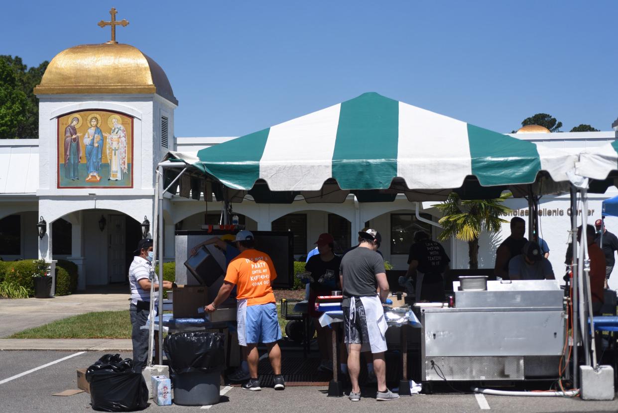 Workers cook food during the annual St. Nicholas Greek Festival at St. Nicholas Greek Orthodox Church in Wilmington, N.C., Saturday, May 15, 2021.