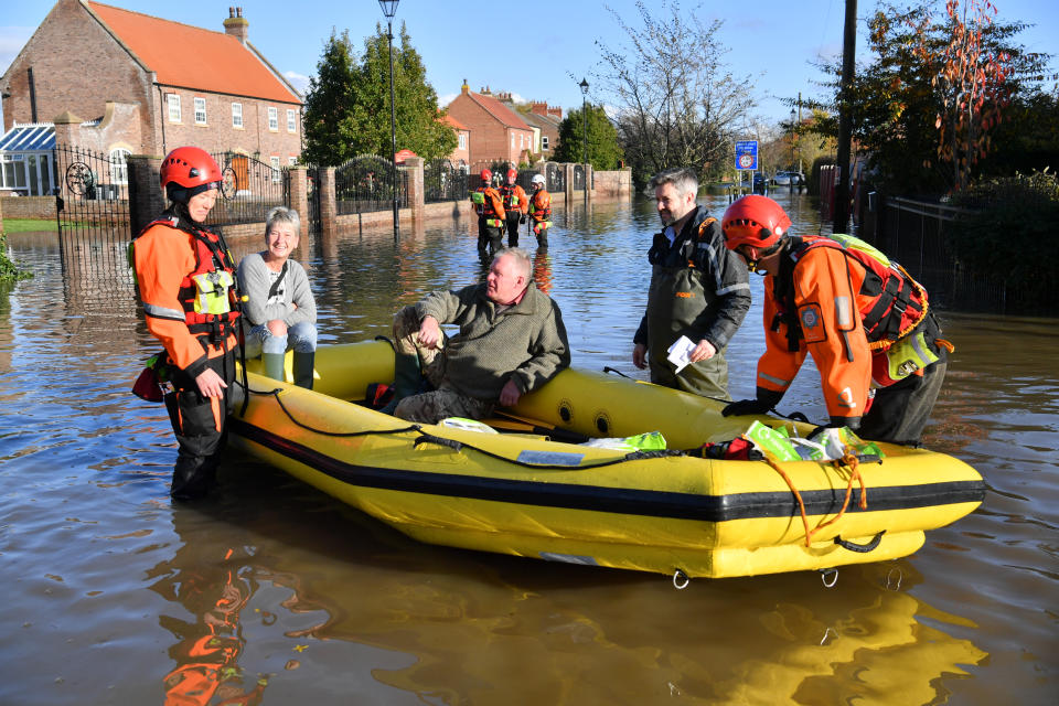 Fire and rescue crews transport people through floodwater to other parts of Fishlake, Doncaster as parts of England endured a month's worth of rain in 24 hours, with scores of people rescued or forced to evacuate their homes. (Photo by Ben Birchall/PA Images via Getty Images)