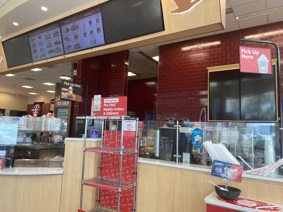 Sandwich counter at Wawa with menu above station