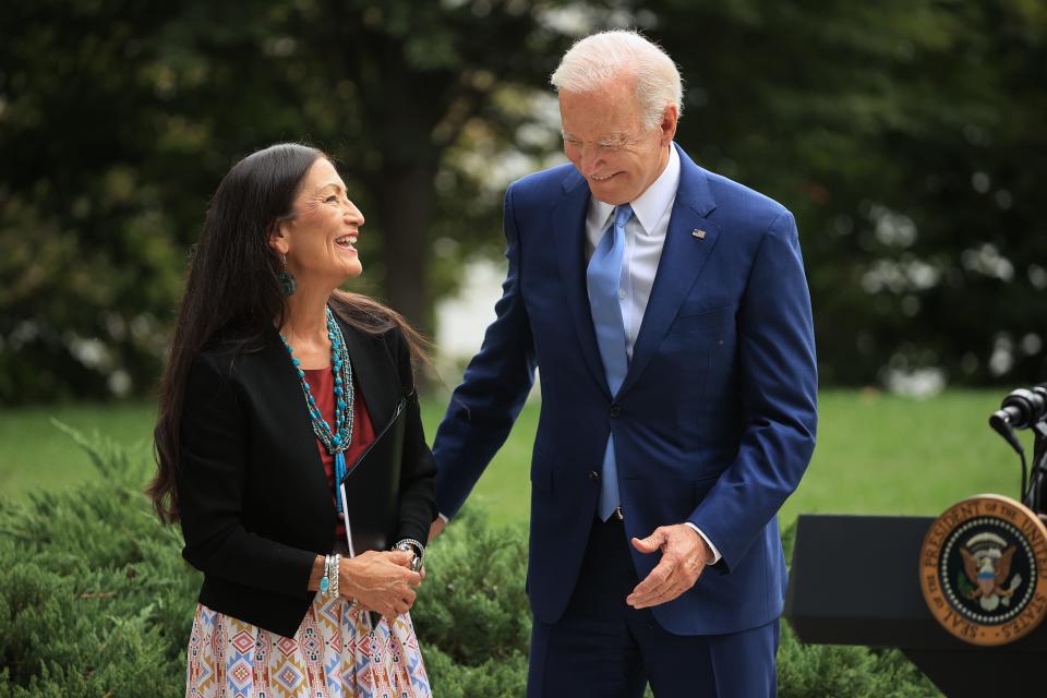 U.S. President Joe Biden and Secretary of the Interior Deb Haaland celebrate the announcement of the expansion of areas of three national monuments at the White House on October 8, 2021. The Biden administration restored the areas of two Utah parks with lands held sacred by several Native American tribes, Bears Ears National Monument and the Grand Staircase-Escalante, as well as the Northeast Canyons and Seamounts of the New England coast, after former President Donald Trump opened them to mining, drilling and development during his time in office.