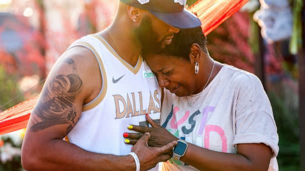 PHOTO: Robert Jackson consoles Cheryl Jackson at a makeshift memorial outside the Allen Premium Outlets, May 8, 2023, in Allen, Texas. (Jeffrey McWhorter/The Washington Post via Getty Images)