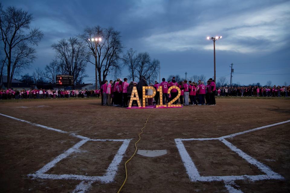 Family and friends gather for Ashton Pryor's candlelight celebration at Mike Wilson Field at Boonville High School in Boonville, Ind., Sunday evening, Feb. 19, 2023. Ashton, a softball player, wore the number 12.