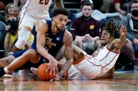 Georgia Tech center Rodney Howard, left, controls a loose ball as Southern California guard Isaiah White, right, falls away from the ball during the first half of an NCAA college basketball game at the Jerry Colangelo Classic Saturday, Dec. 18, 2021, in Phoenix. (AP Photo/Ross D. Franklin)