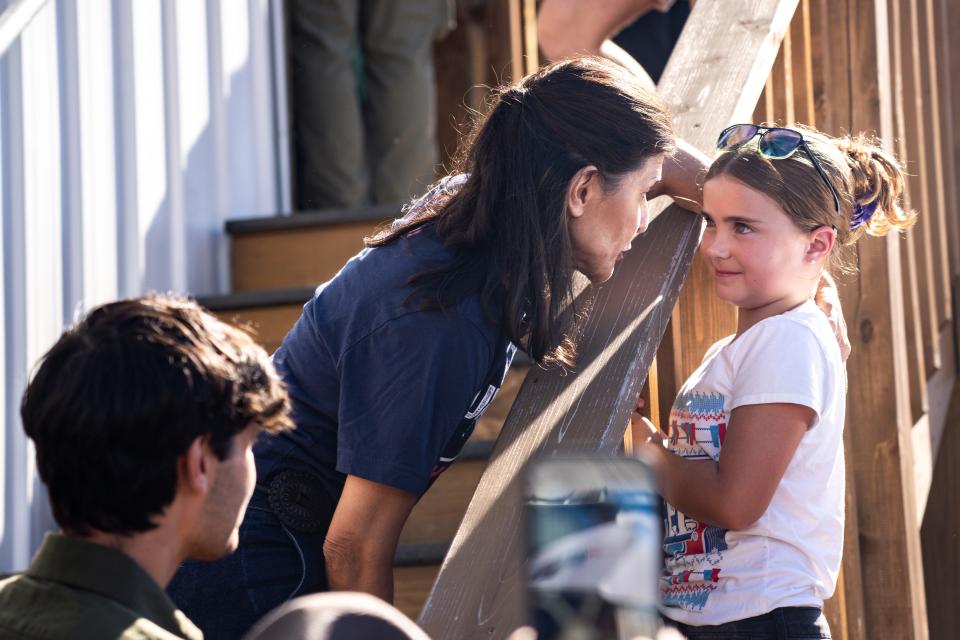 GOP presidential candidate Nikki Haley speaks with a young girl during Gov. Kim Reynolds' Fair-Side Chat during day three of the Iowa State Fair on Saturday, August 12, 2023 in Des Moines.