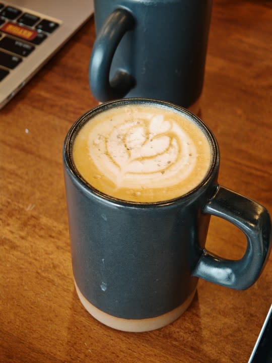 A photo of a coffee cup with a heart drawn on top, taken with the Honor Magic 6 RSR.