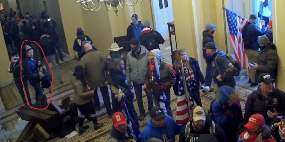 A security footage still from the FBI filing showing a group people inside the Capitol. The man who the FBI believe is Gary Edwards is circled.