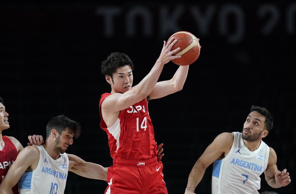 Japan's Kosuke Kanamaru (14) grabs a rebound over Argentina's Facundo Campazzo (7), right, during men's basketball preliminary round game at the 2020 Summer Olympics, Sunday, Aug. 1, 2021, in Saitama, Japan. (AP Photo/Charlie Neibergall)