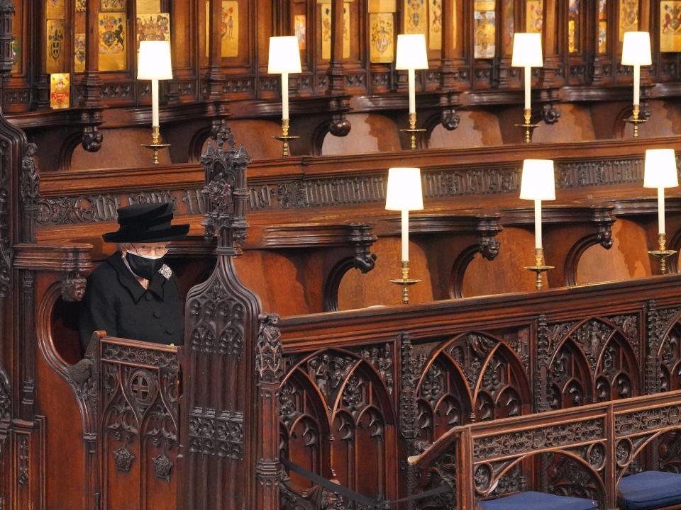 Queen Elizabeth II sits alone at Prince Philip's funeral.