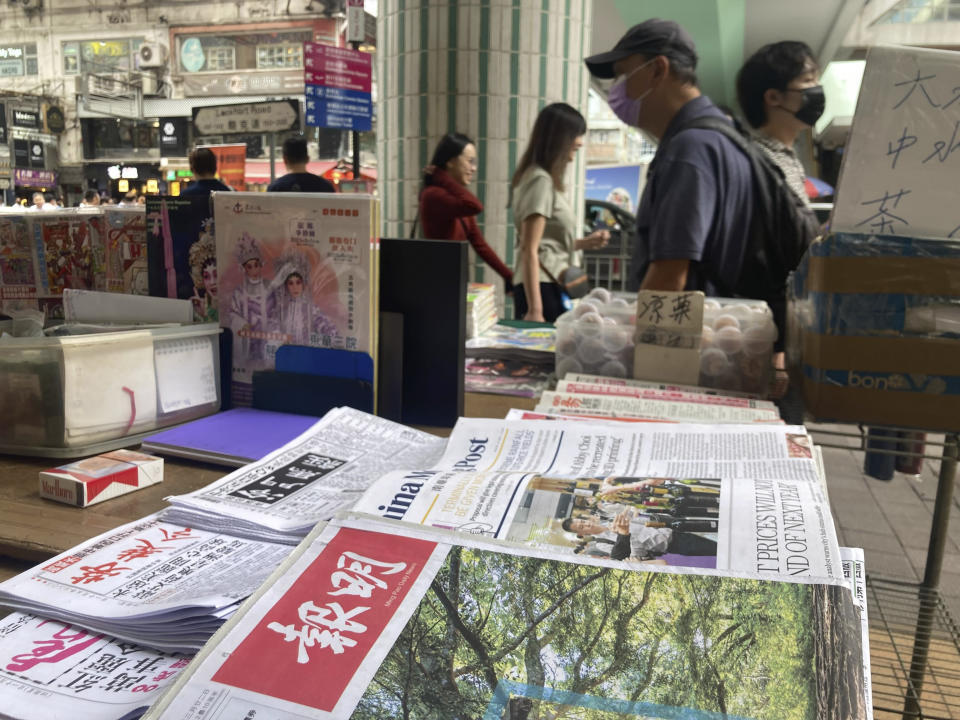 A copy of the Chinese-language newspaper Ming Pao, foreground, is seen at a newsstand in Hong Kong, Thursday, May 11, 2023. A Hong Kong newspaper will stop publishing works by the city's most prominent political cartoonist after his drawings drew government complaints, in another example of hushed speech and media voices after a Beijing-led crackdown. (AP Photo/Kanis Leung)
