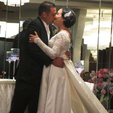 The bride kisses her new husband in her aunt's vintage gown.