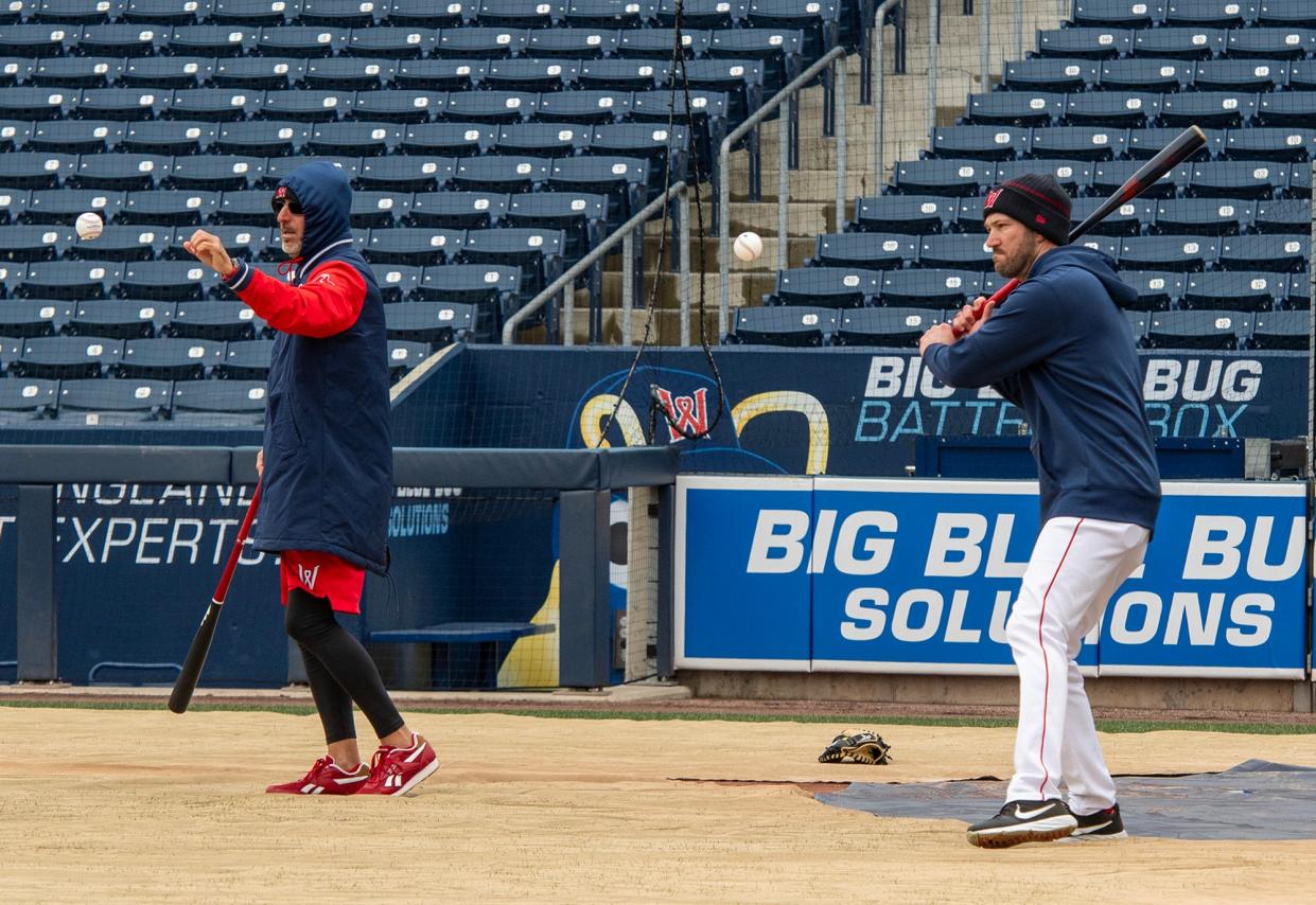 Bench coach José David Flores, left, and manager Chad Tracy hit ground balls to infielders on the first day of practice at Polar Park Tuesday.