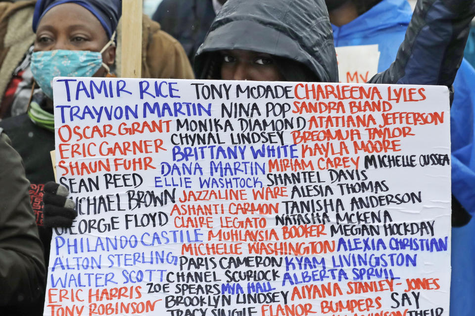 A person holds a sign with the names of people who have died due to police brutality and other incidents during a "March of Silence" against racial inequality and police brutality that was organized by Black Lives Matter Seattle-King County, Friday, June 12, 2020, in Seattle. People marched for nearly two miles to support Black lives, oppose racism and to call for police reforms among other issues. (AP Photo/Ted S. Warren)