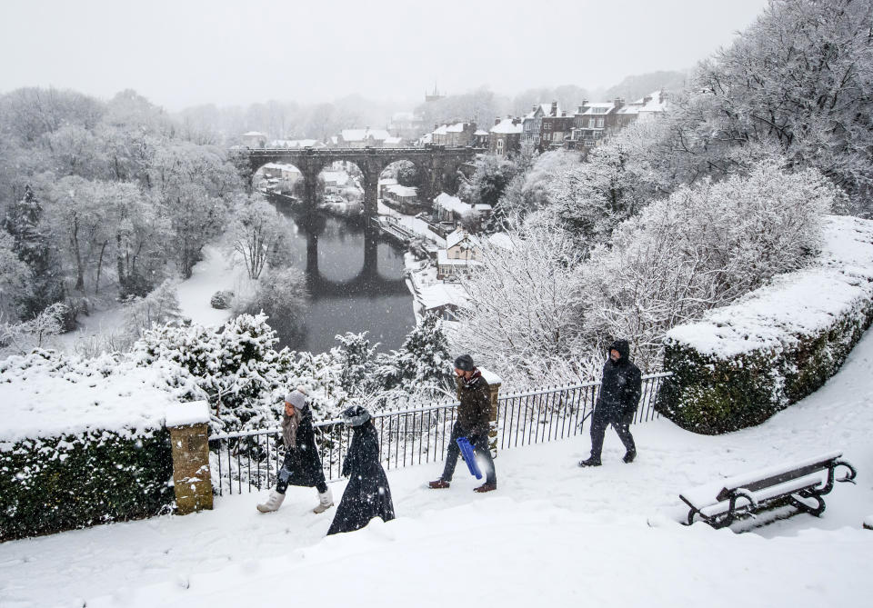 People walk near Knaresborough Viaduct after snow fell in North Yorkshire.