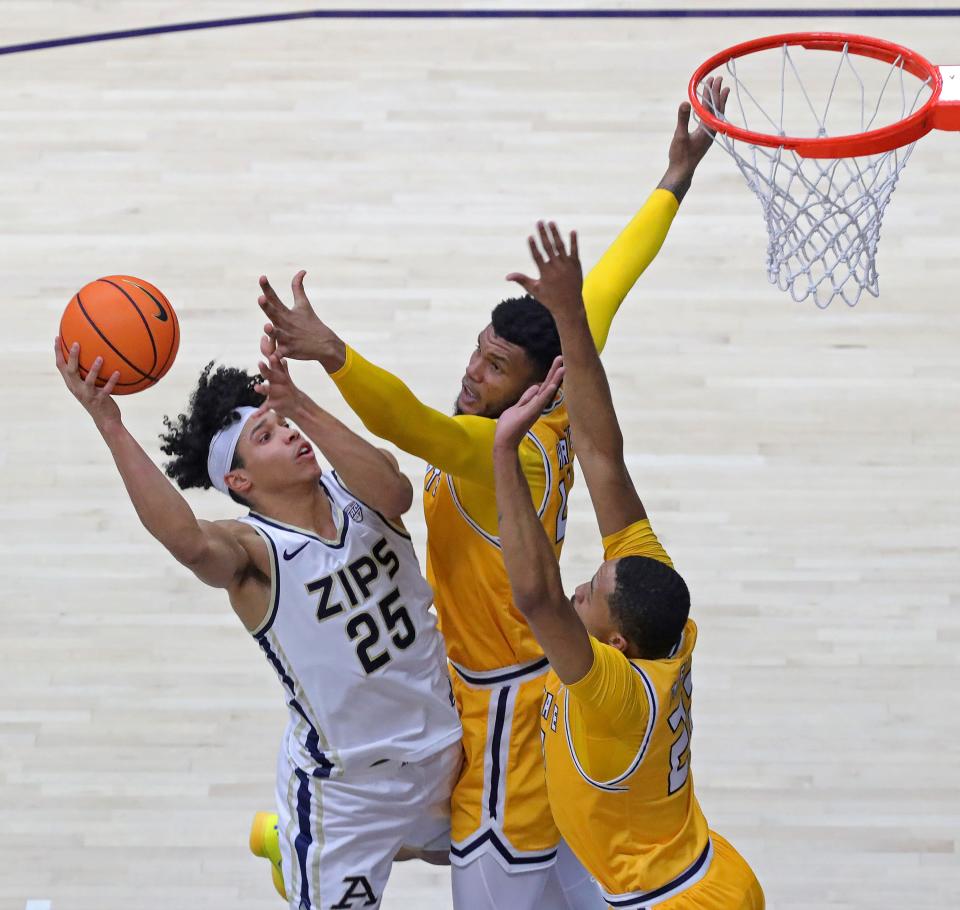 Akron Zips forward Enrique Freeman shoots over Kent State center Cli'Ron Hornbeak (42) and guard Tyem Freeman (22) during the first half, Friday, Feb. 23, 2024.