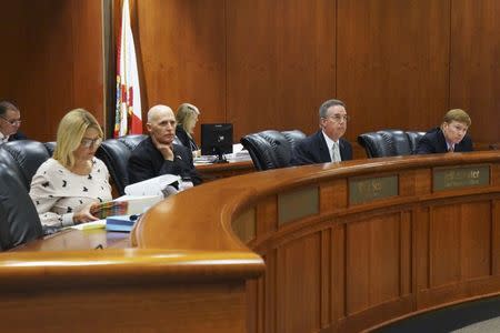 Florida state's clemency board, overseeing the restoration of voting rights to felons, L-R, Florida Attorney General Pam Bondi, Governor Rick Scott, Chief Financial Officer Jeff Atwater, and Commissioner of Agriculture and Consumer Services Adam Putnam, listen during a public meeting in Tallahassee, Florida, U.S. on September 21, 2016. Picture taken on September 21, 2016. REUTERS/Letitia Stein